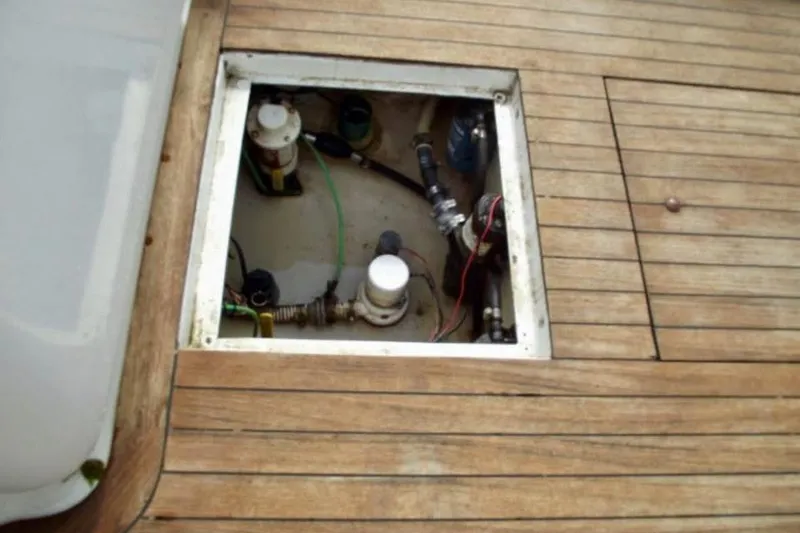 Slide: The Image of Interior of 2006 Calyber 29 Express boat with wooden helm and white seating. - 10