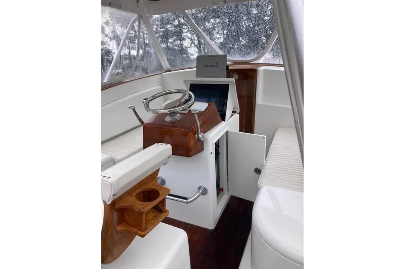 Slide: The Image of 2006 Calyber 29 Express boat with dual outboard engines in a driveway setting. - 13