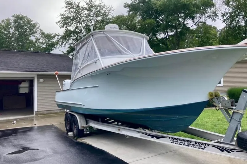 Slide: The Image of 2006 Calyber 29 Express boat cruising on open water. - 2