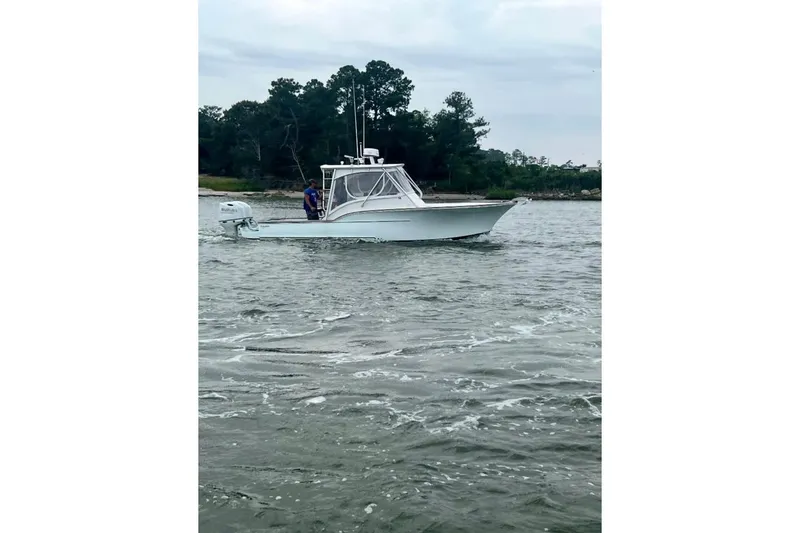 Slide: The Image of Interior cabin of 2006 Calyber 29 Express boat with cushioned seating. - 5