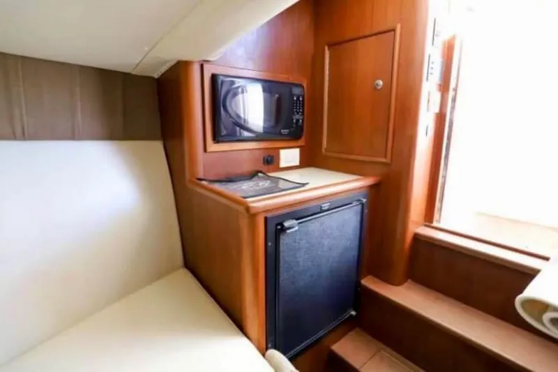 Slide: The Image of 2006 Calyber 29 Express boat interior with compact wooden bathroom and toilet. - 7