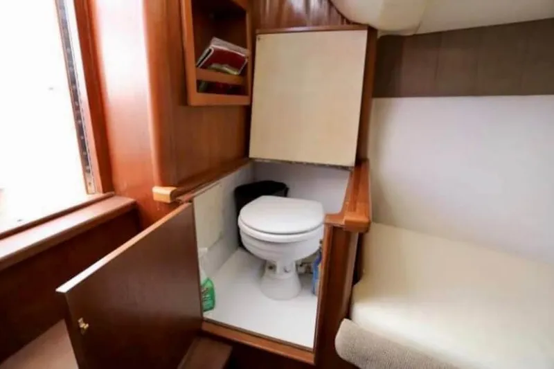 Slide: The Image of 2006 Calyber 29 Express boat with wooden deck and built-in storage compartment. - 8