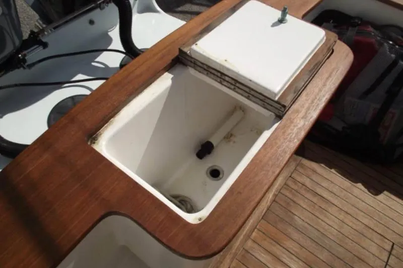 Slide: The Image of Open hatch on 2006 Calyber 29 Express boat deck showing internal components. - 9