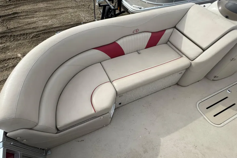 Slide: The Image of 2014 Avalon Windjammer Fish 24' boat interior with beige and red seating. - 5