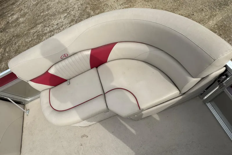 Slide: The Image of 2014 Avalon Windjammer Fish 24' boat seating with beige and red upholstery. - 6