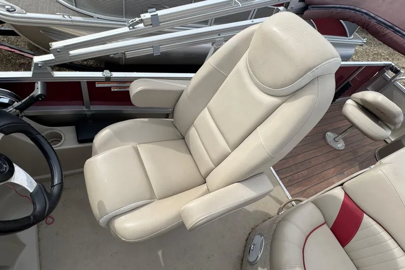 Slide: The Image of 2014 Avalon Windjammer Fish boat interior with beige captain's chair and steering wheel. - 9