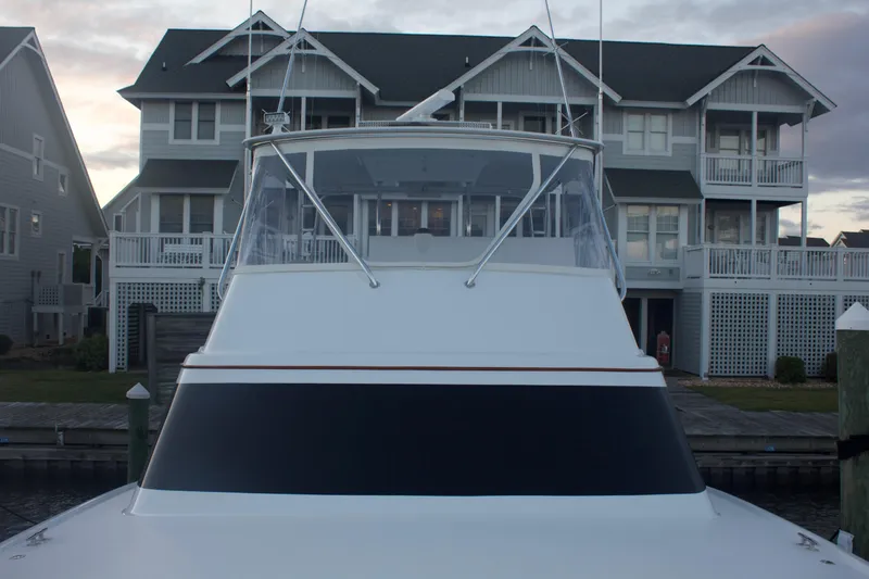 Slide: The Image of 2004 Hudson Custom Carolina yacht docked by coastal house. - 12