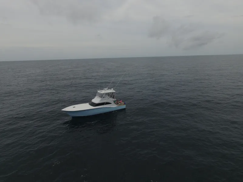 Slide: The Image of 2004 Hudson Custom Carolina boat on open sea. - 3