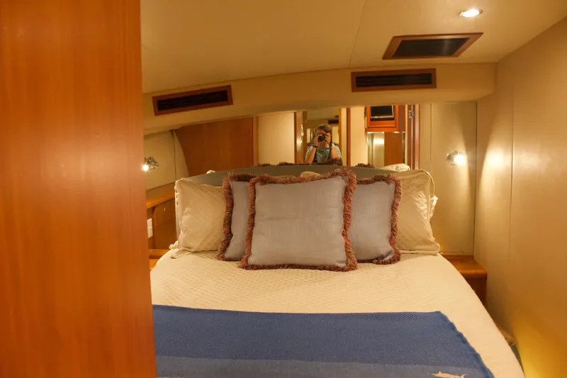 Slide: The Image of Interior of a 2004 Hudson Custom Carolina boat, cozy bedroom with pillows. - 32