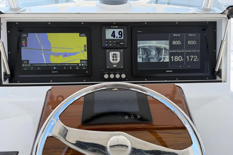 Slide: The Image of Dashboard of a 2004 Hudson Custom Carolina boat with navigation screens and controls. - 45