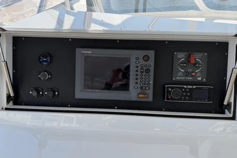 Slide: The Image of Control panel of a 2004 Hudson Custom Carolina boat with navigation and backup systems. - 46