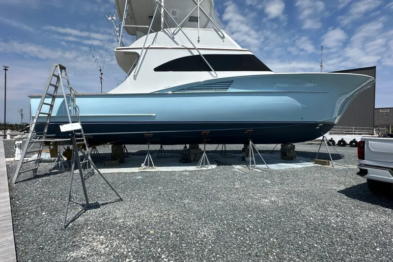 Slide: The Image of 2004 Hudson Custom Carolina boat on stands, blue hull, clear sky background. - 48