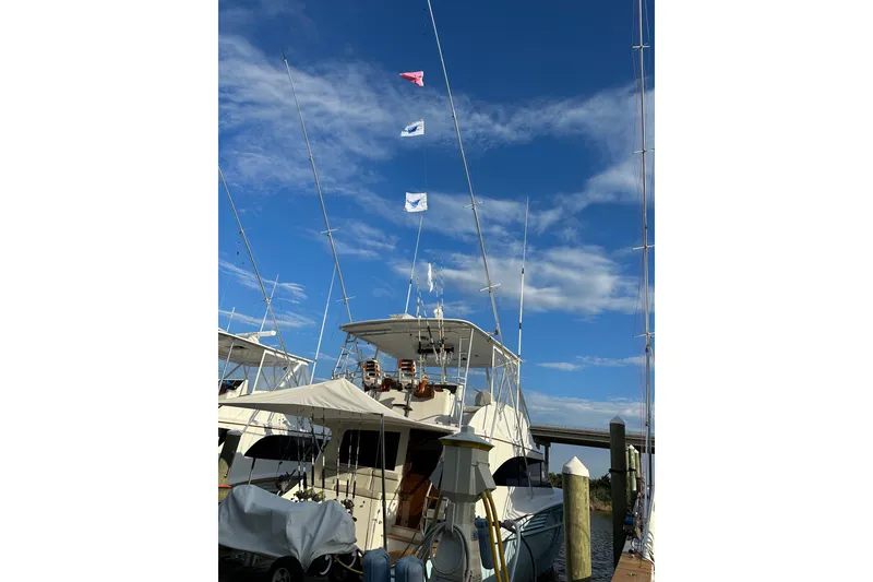 Slide: The Image of A 2004 Hudson Custom Carolina boat docked under a clear blue sky. - 49