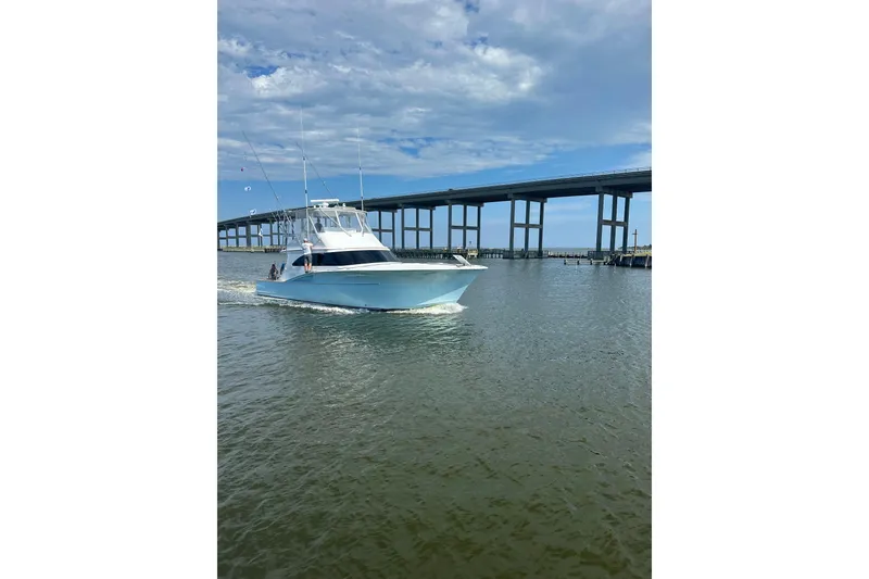 Slide: The Image of 2004 Hudson Custom Carolina boat cruising under a bridge on a sunny day. - 50