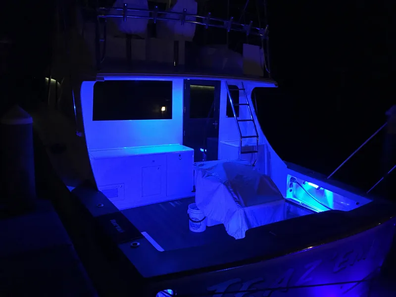 Slide: The Image of 2004 Hudson Custom Carolina boat illuminated with blue lights at night. - 7