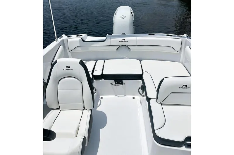 Slide: The Image of Manufacturer Provided Image: 2026 Stingray 172 DC boat interior with white seating and sleek design on water. - 13