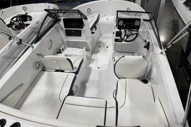 Slide: The Image of 2026 Stingray 172 DC boat interior with white seating and dual consoles. - 2