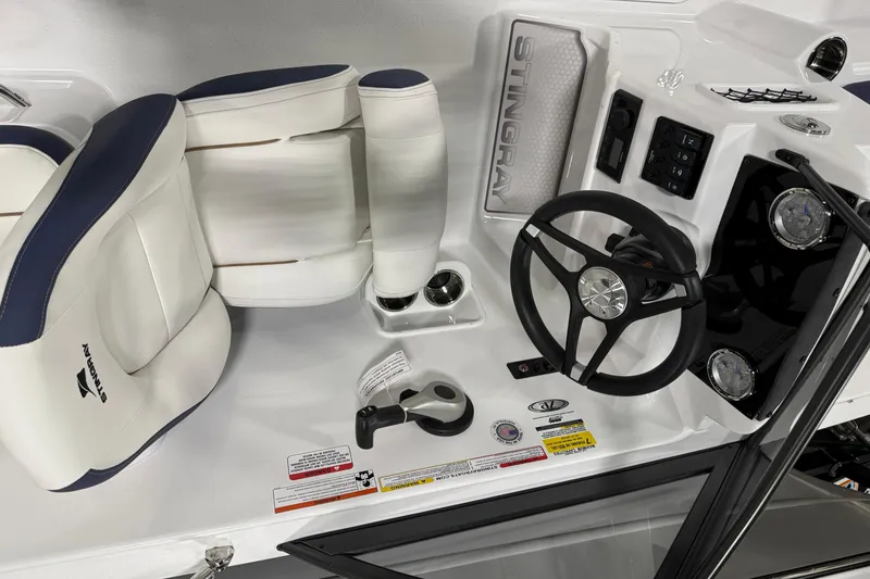 Slide: The Image of 2026 Stingray 172 DC boat interior with steering wheel and seating. - 3