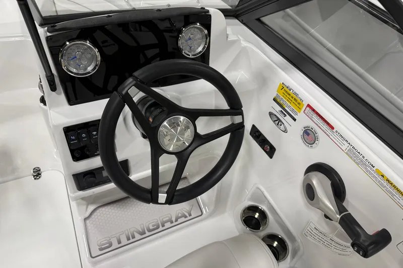 Slide: The Image of Steering wheel and dashboard of 2026 Stingray 172 DC boat, featuring modern controls and gauges. - 4