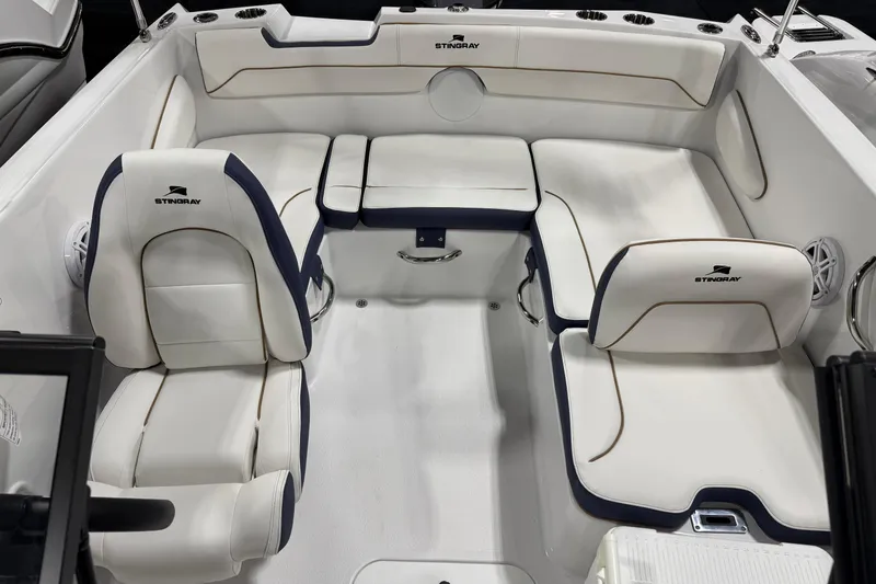 Slide: The Image of 2026 Stingray 172 DC boat interior with white seating and logo detailing. - 7