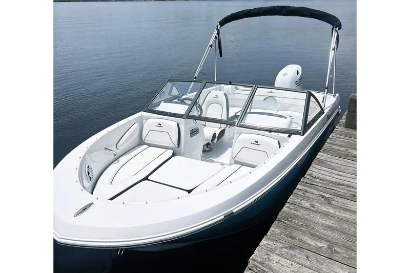 Slide: The Image of Manufacturer Provided Image: 2026 Stingray 172 DC boat docked on calm water, featuring sleek design and comfortable seating. - 9