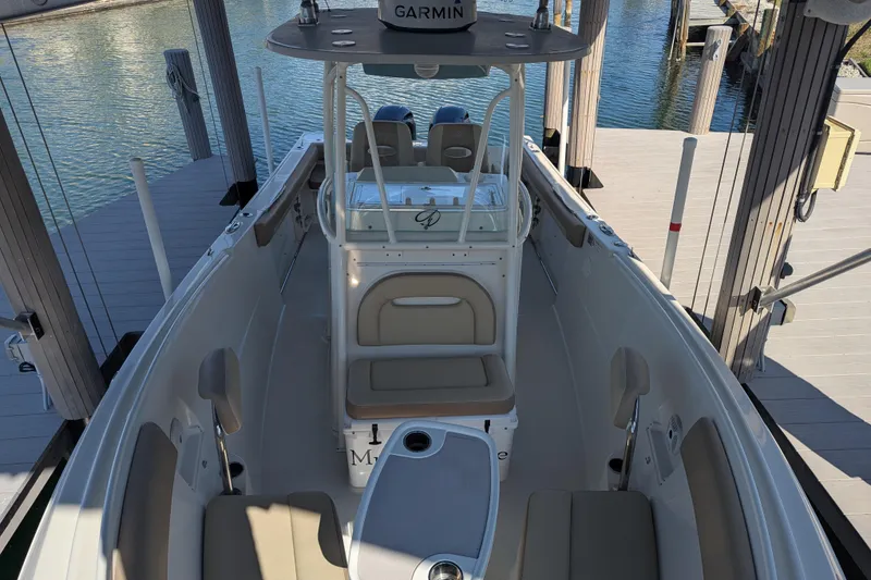 Slide: The Image of 2018 Sailfish 270 CC boat docked, featuring Garmin equipment and spacious seating. - 10