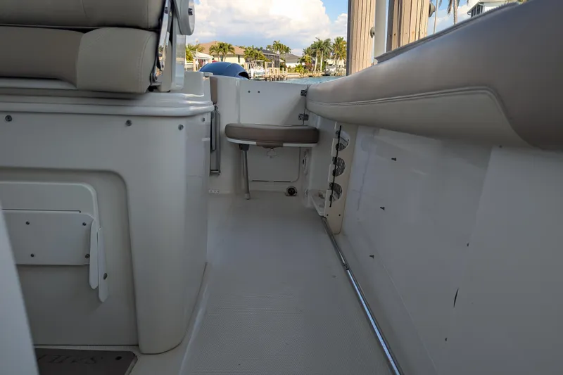 Slide: The Image of Interior view of a 2018 Sailfish 270 CC boat, showcasing seating and storage. - 11