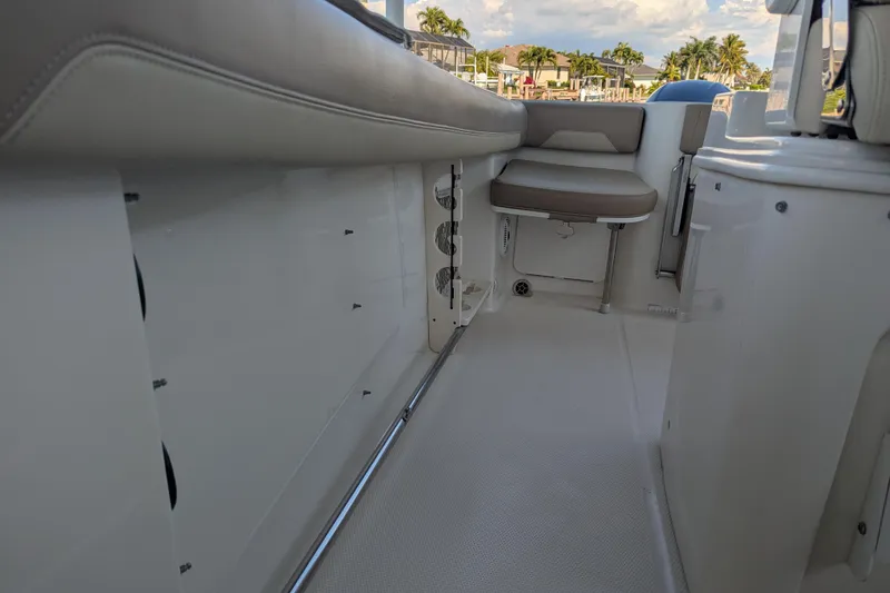 Slide: The Image of 2018 Sailfish 270 CC boat interior with seating and storage compartments. - 12
