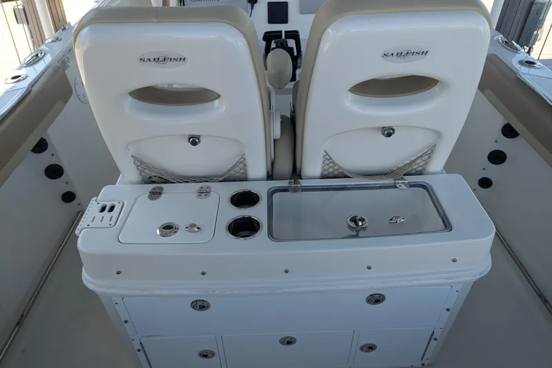 Slide: The Image of 2018 Sailfish 270 CC boat interior with dual seats and fishing station. - 13