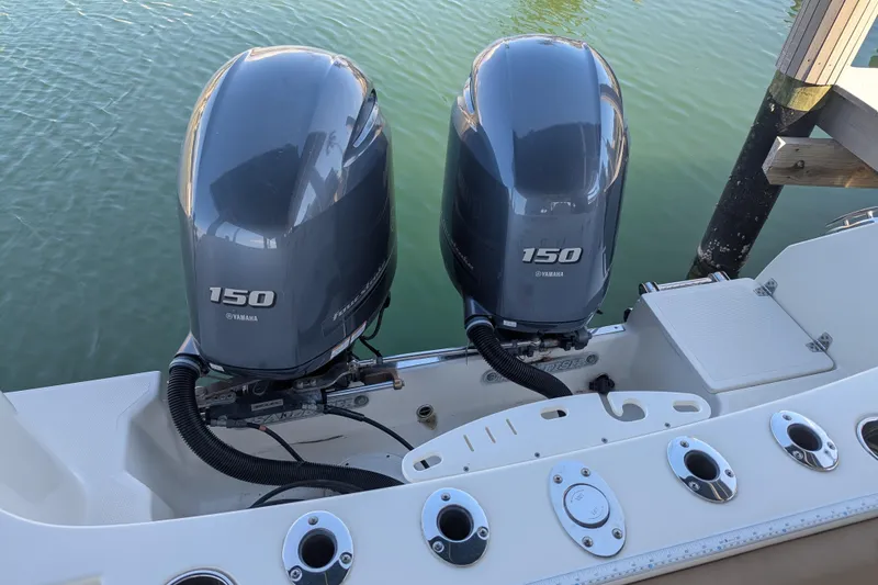 Slide: The Image of Twin Yamaha 150 engines on a 2018 Sailfish 270 CC boat at dock. - 15