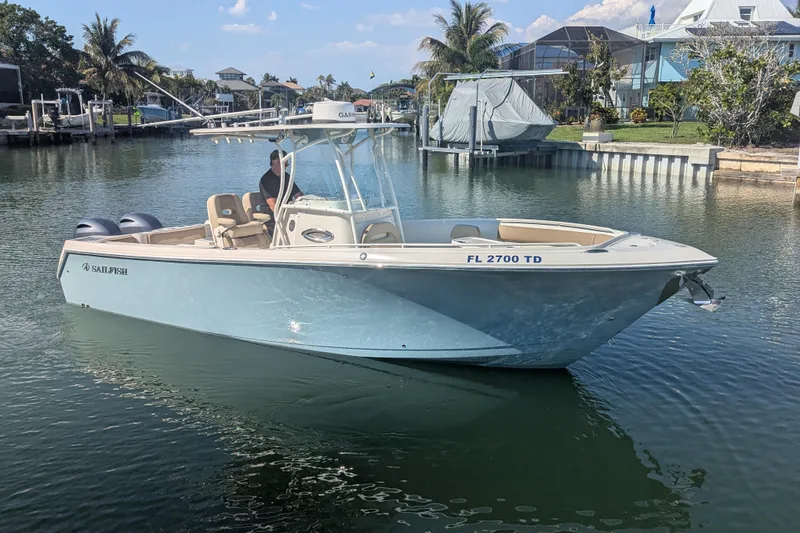 Slide: The Image of 2018 Sailfish 270 CC boat on calm water, surrounded by tropical scenery. - 3