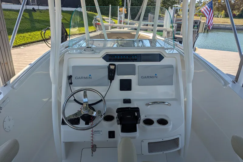 Slide: The Image of 2018 Sailfish 270 CC boat helm with Garmin navigation system and steering wheel. - 6