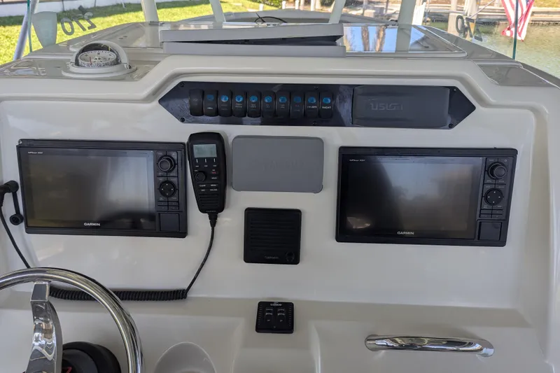 Slide: The Image of 2018 Sailfish 270 CC boat dashboard with Garmin displays and navigation controls. - 7