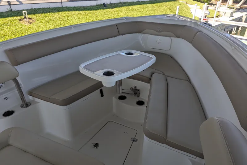 Slide: The Image of 2018 Sailfish 270 CC boat interior with cushioned seating and a central table. - 9