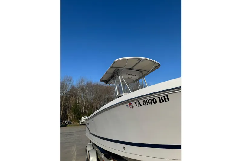 Slide: The Image of 2007 PROLINE 23 Sport boat on trailer under clear blue sky. - 2