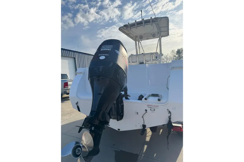 Slide: The Image of 2007 PROLINE 23 Sport boat with Suzuki 225 outboard motor, docked under a blue sky. - 4