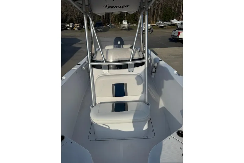 Slide: The Image of 2007 PROLINE 23 Sport boat interior with seating and console, parked outdoors. - 8