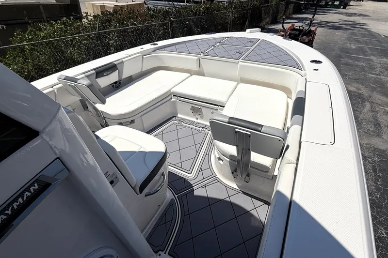 Slide: The Image of 2022 Robalo 266 Cayman boat interior with cushioned seating and sleek design. - 15