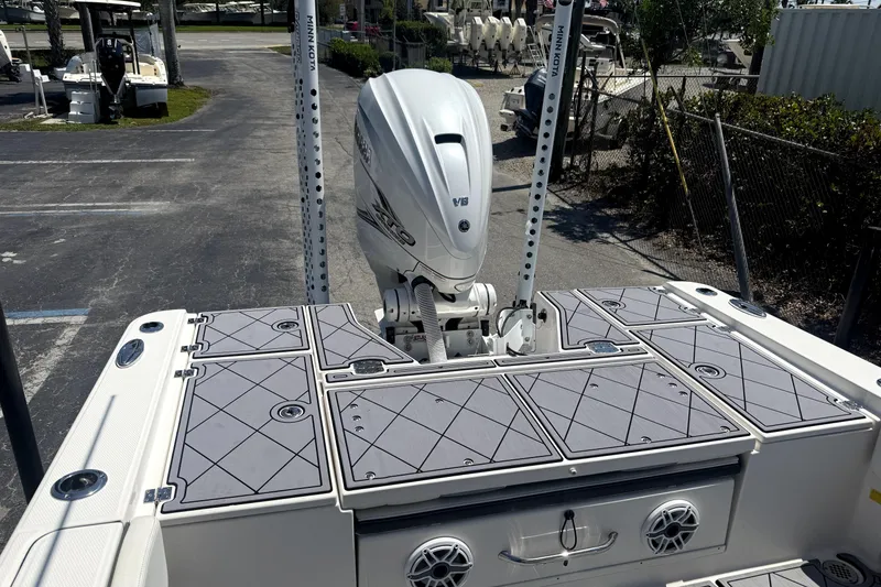 Slide: The Image of 2022 Robalo 266 Cayman boat with Yamaha V6 engine, docked in a marina. - 4