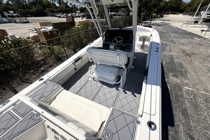 Slide: The Image of 2022 Robalo 266 Cayman boat interior with helm, seating, and storage compartments. - 7