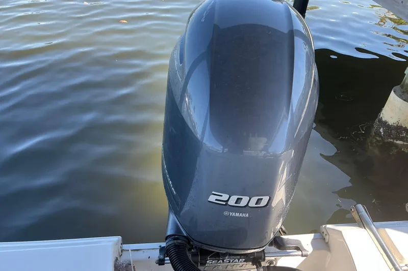 Slide: The Image of Yamaha 200 outboard motor on 2016 Sea Hunt Ultra 225 boat, docked on calm water. - 20