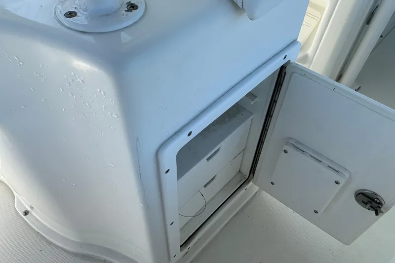Slide: The Image of Open storage compartment on a 2016 Sea Hunt Ultra 225 boat. - 21