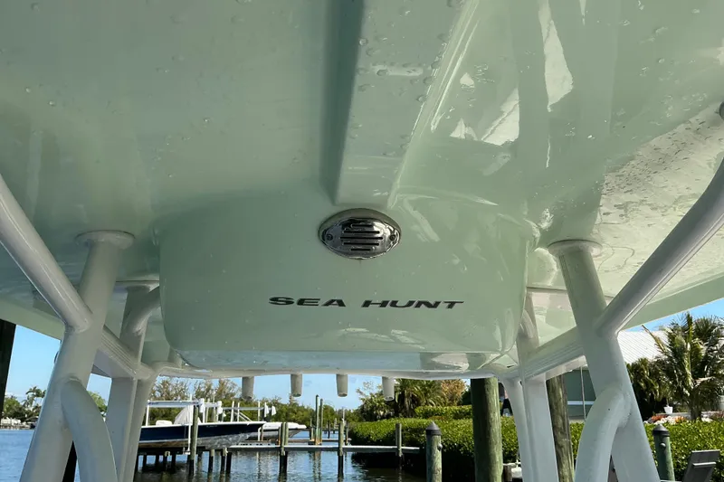 Slide: The Image of 2016 Sea Hunt Ultra 225 boat underside view at dock. - 24
