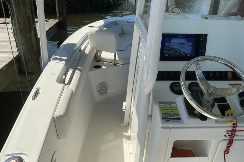 Slide: The Image of 2016 Sea Hunt Ultra 225 boat interior with steering wheel and navigation display. - 26