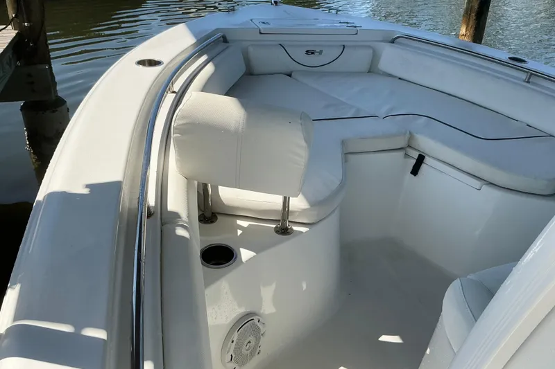 Slide: The Image of 2016 Sea Hunt Ultra 225 boat interior with cushioned seating and cup holders. - 29