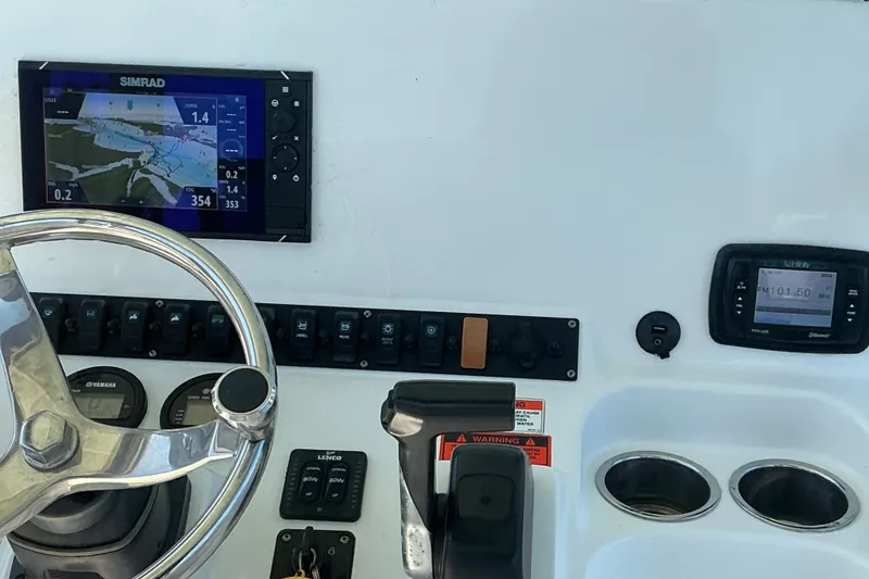 Slide: The Image of 2016 Sea Hunt Ultra 225 dashboard with Simrad navigation and steering wheel. - 33