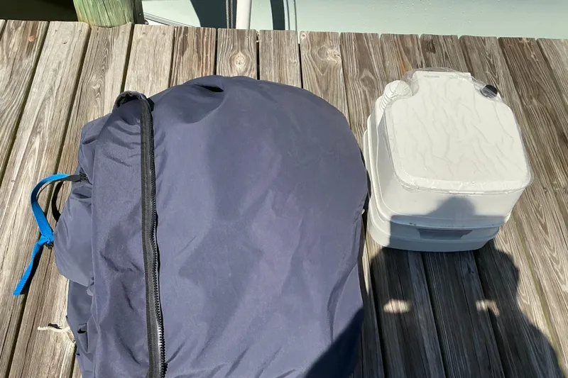 Slide: The Image of Blue bag and white container on wooden dock, related to 2016 Sea Hunt Ultra 225. - 35