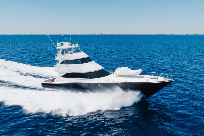 The Image of 2016 Viking 82 Sky Bridge yacht cruising on open blue sea. - 1