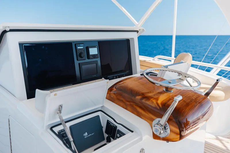 Slide: The Image of Control panel of 2016 Viking 82 Sky Bridge yacht with ocean view. - 10