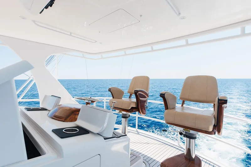 Slide: The Image of Luxurious 2016 Viking 82 Sky Bridge yacht interior with ocean view and elegant seating. - 11
